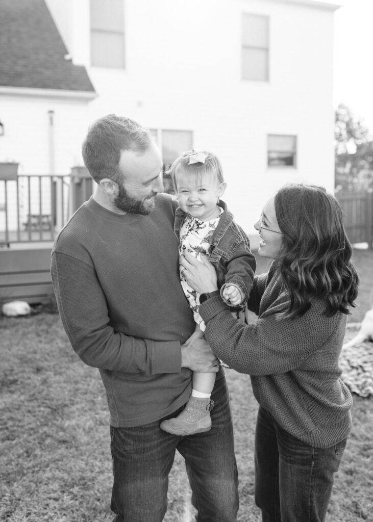 A family with a young toddler laughing together