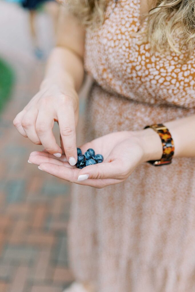 A close-up of blueberries in a lady's hand