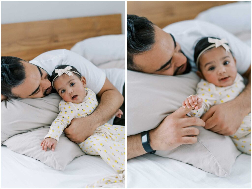 A dad cuddles with his baby daughter in bed