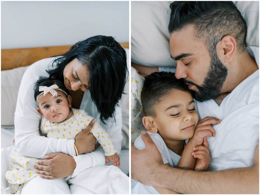 A family with a mom, a dad, a baby girl, and a young boy cuddles in their white pillows and bedsheets