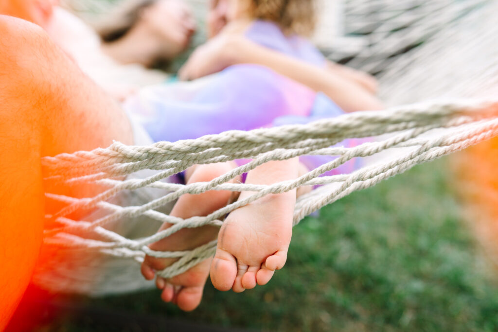 a close-up of a little girl's feet in a hammock 