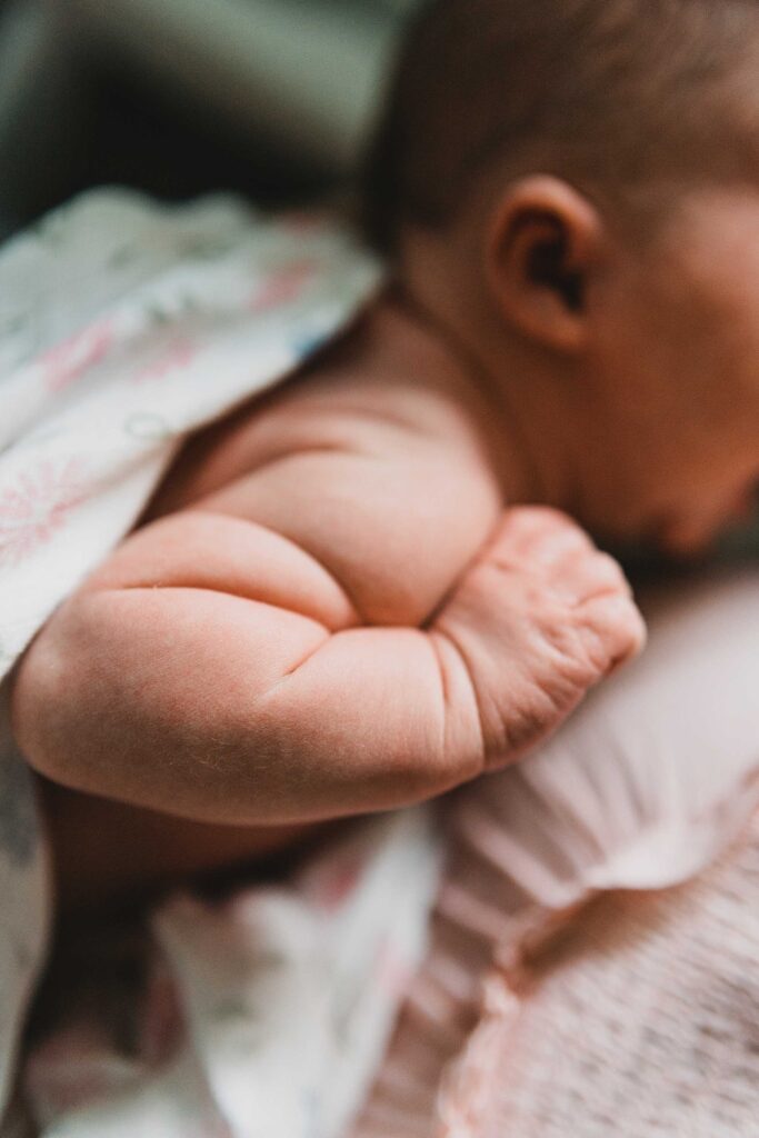 A close-up of chubby rolls of a baby's arm