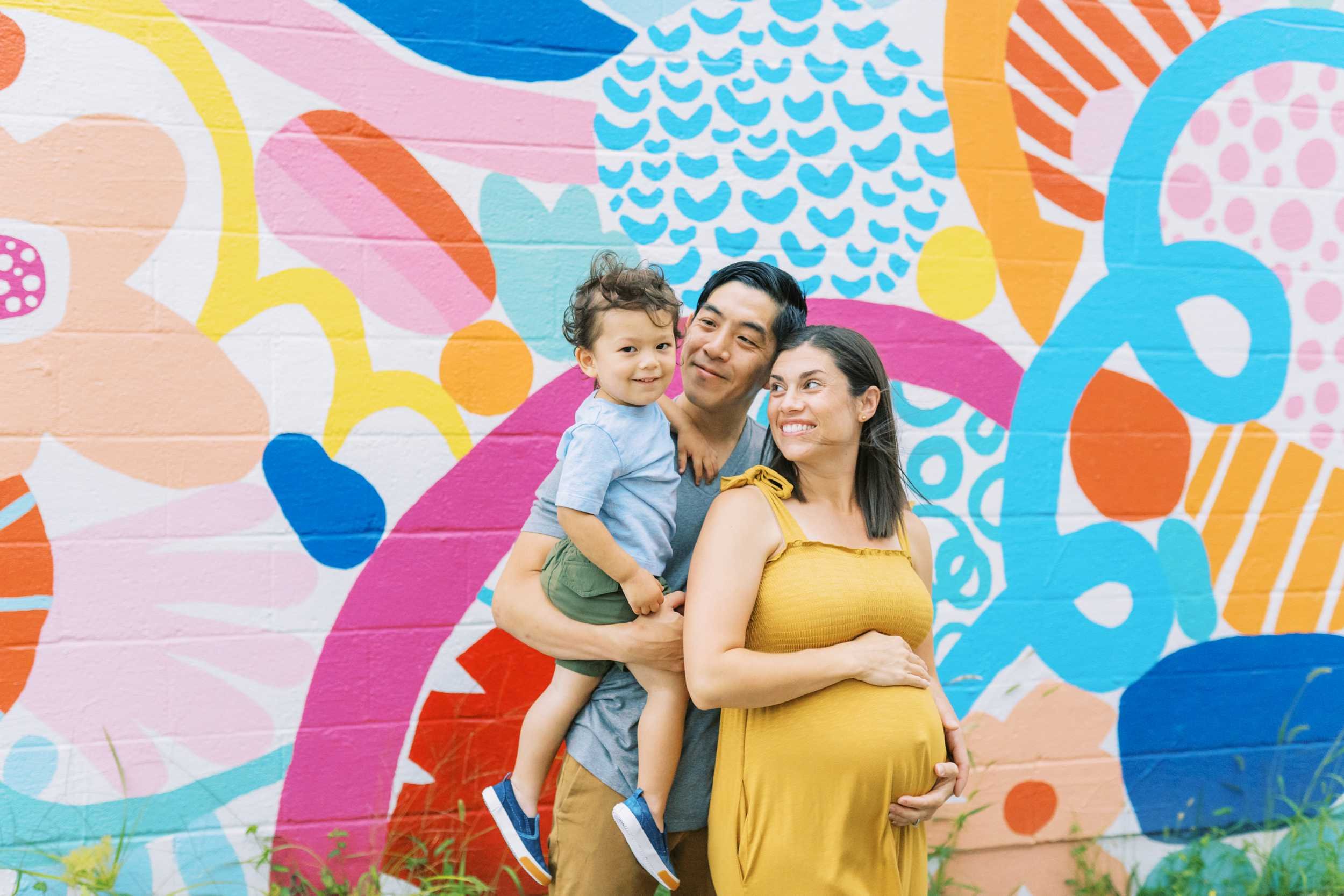 A family standing in front of an abstract painted wall in Columbus Ohio