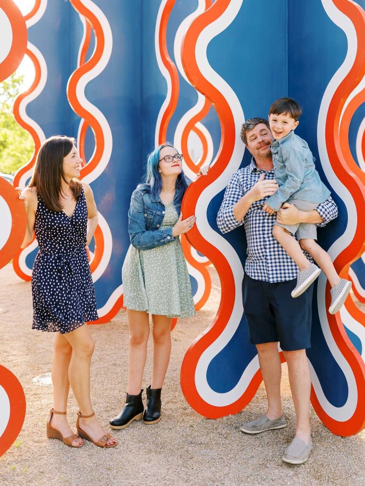 A family standing in front of a blue street art statue outside of the Columbus Museum of Art in Ohio