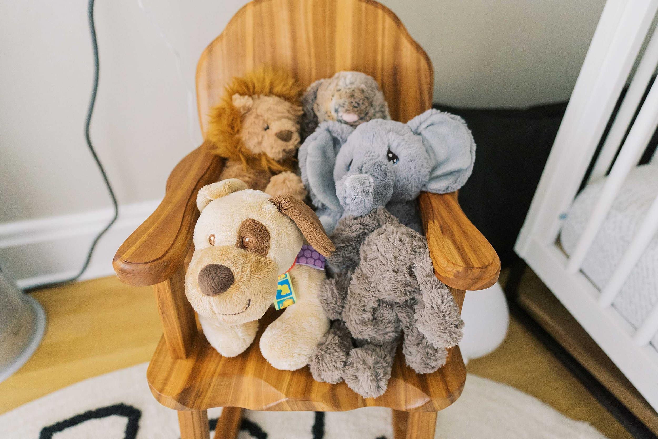Stuffed animals sitting on a child's rocking chair