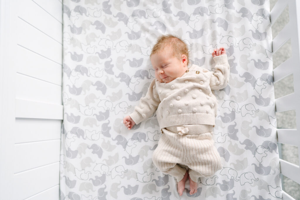 A portrait of a baby sleeping in her crib by Columbus Ohio newborn photographer Daisy Zimmer