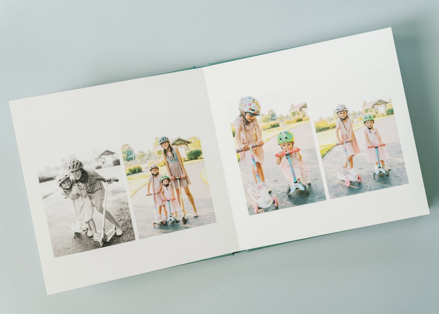 A photo album containing pictures of two sisters riding their scooters